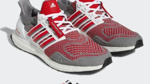 View of grey and red adidas shoes.